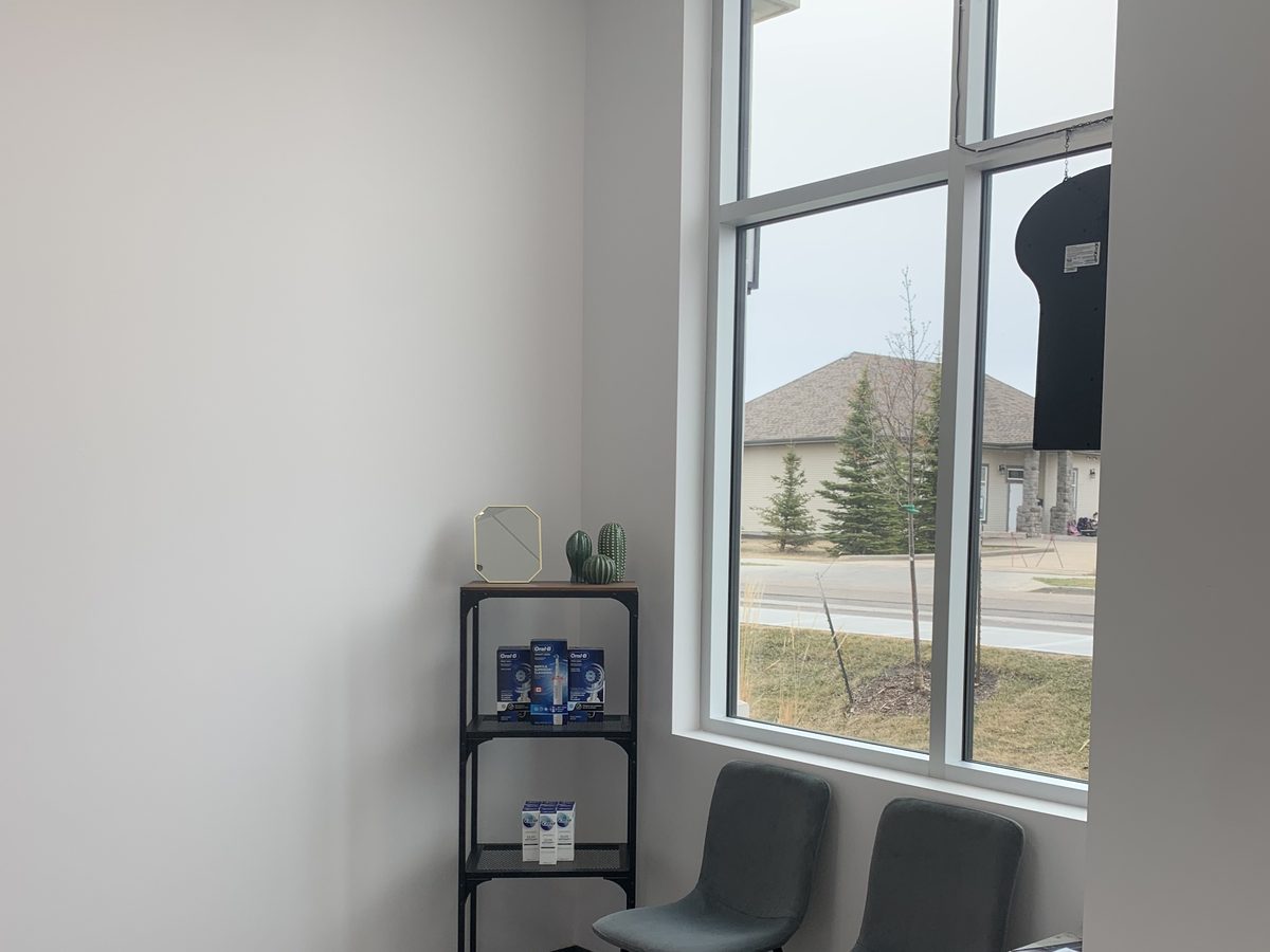 Waiting area seating by the window at Serenity Dental